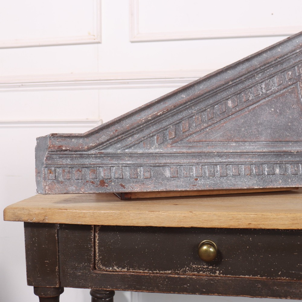 A 19th-century grey metal broken pediment overdoor fragment with classical moulding and a central urn pedestal motif. View II