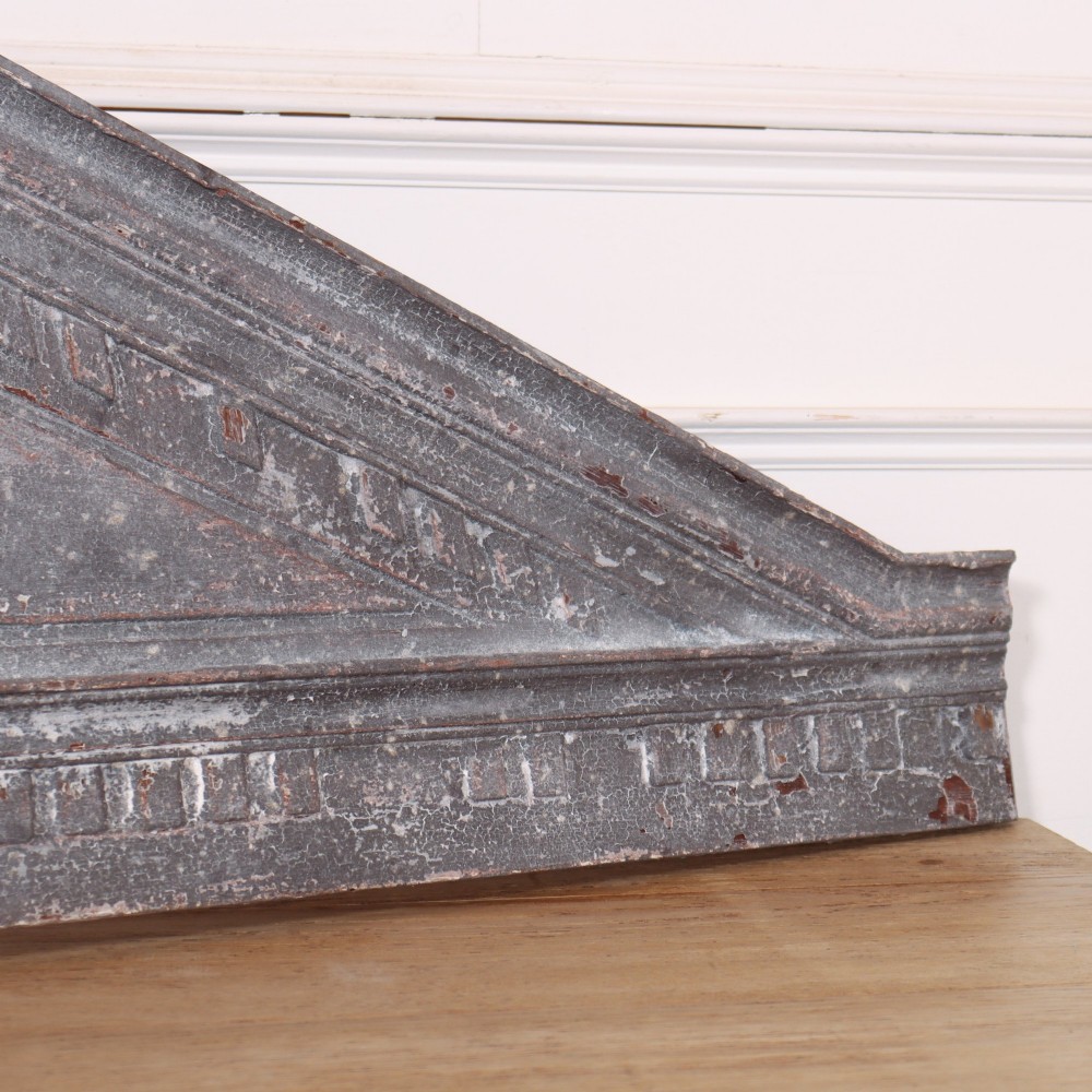 A 19th-century grey metal broken pediment overdoor fragment with classical moulding and a central urn pedestal motif. View V