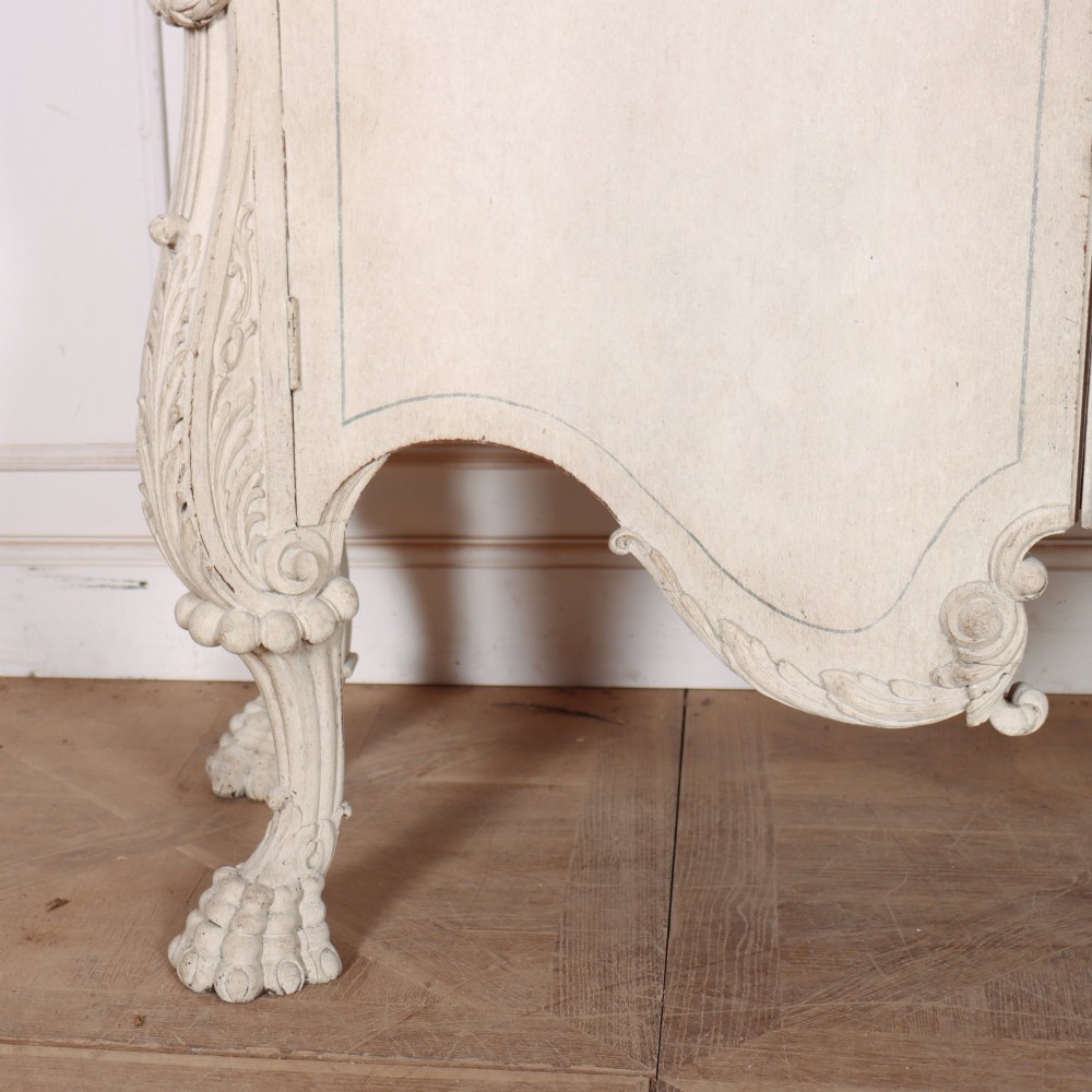 An off-white painted Italian Rococo side cabinet featuring carved acanthus leaf shoulders, a serpentine lower apron, double doors with painted blue trim, and prominent carved claw feet. View II