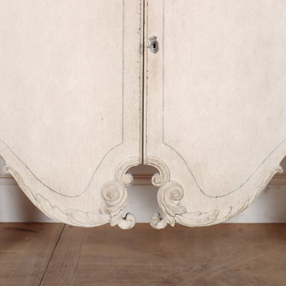 An off-white painted Italian Rococo side cabinet featuring carved acanthus leaf shoulders, a serpentine lower apron, double doors with painted blue trim, and prominent carved claw feet. View VI
