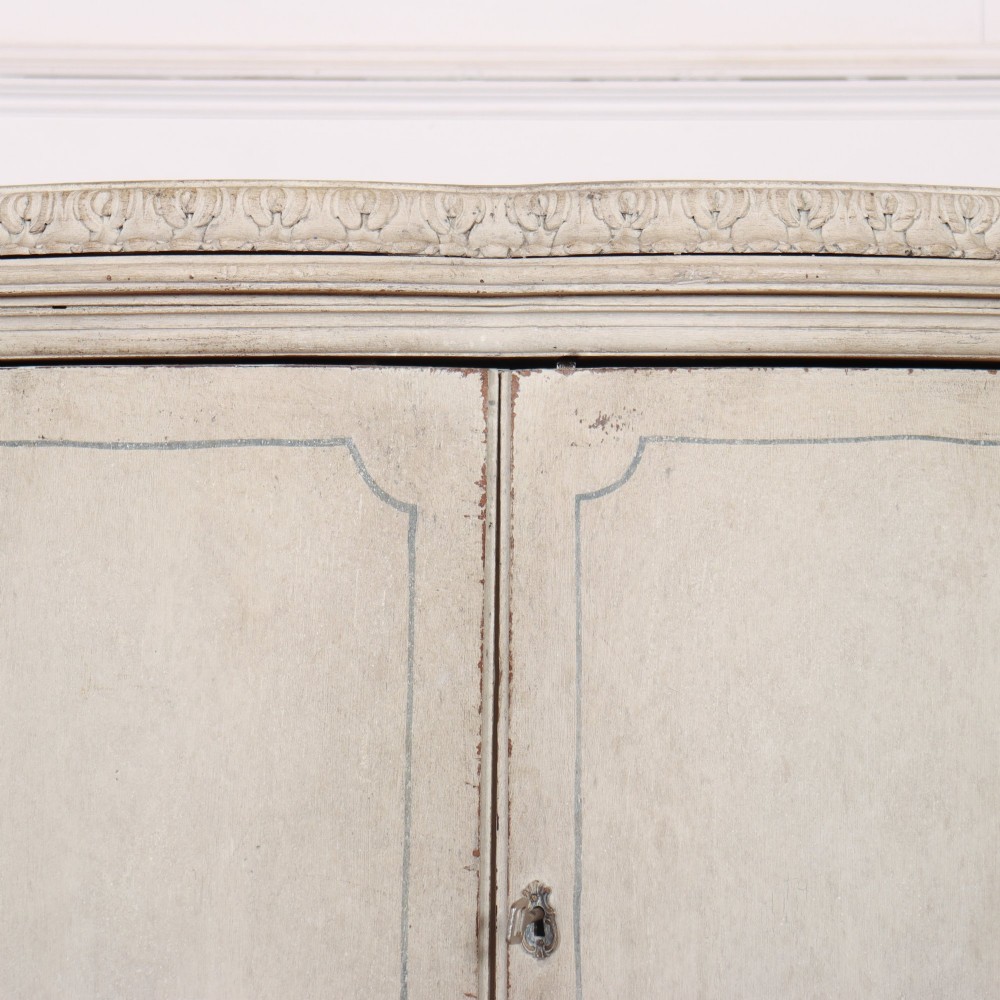 An off-white painted Italian Rococo side cabinet featuring carved acanthus leaf shoulders, a serpentine lower apron, double doors with painted blue trim, and prominent carved claw feet. View VII