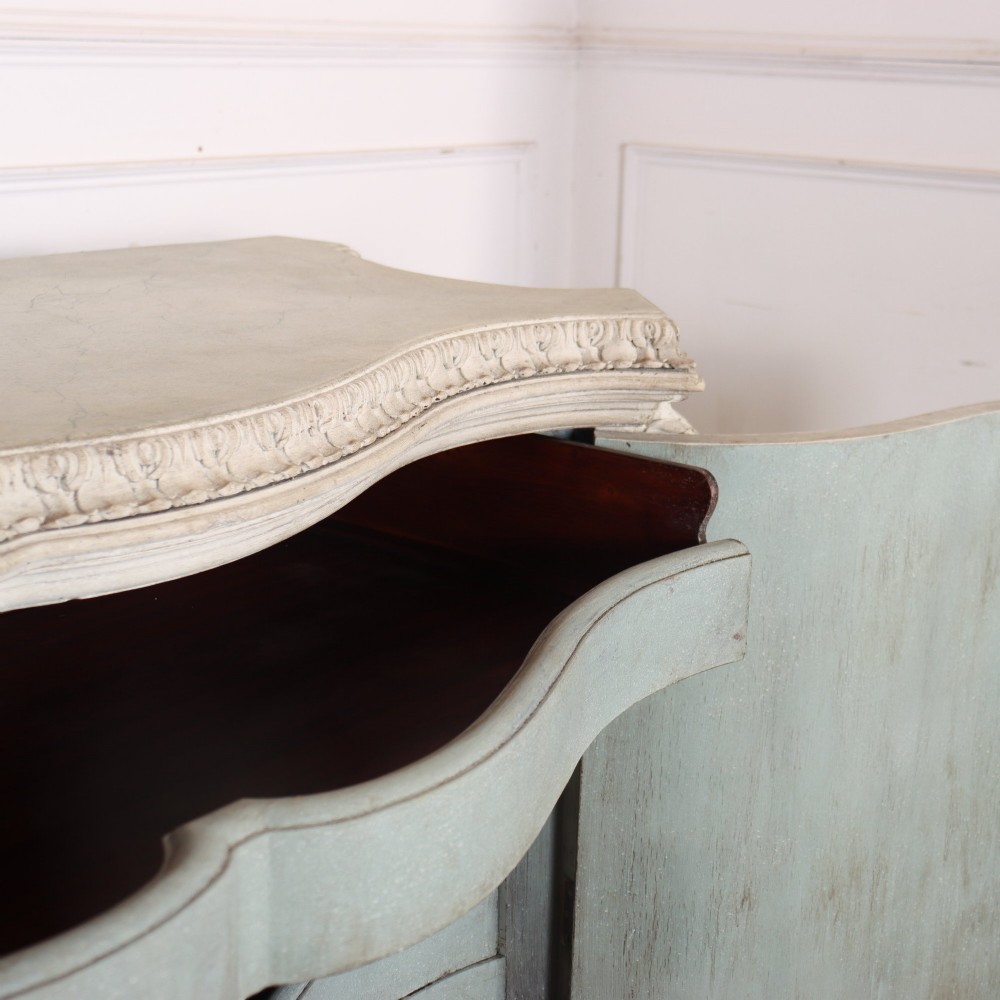 An off-white painted Italian Rococo side cabinet featuring carved acanthus leaf shoulders, a serpentine lower apron, double doors with painted blue trim, and prominent carved claw feet. View IX