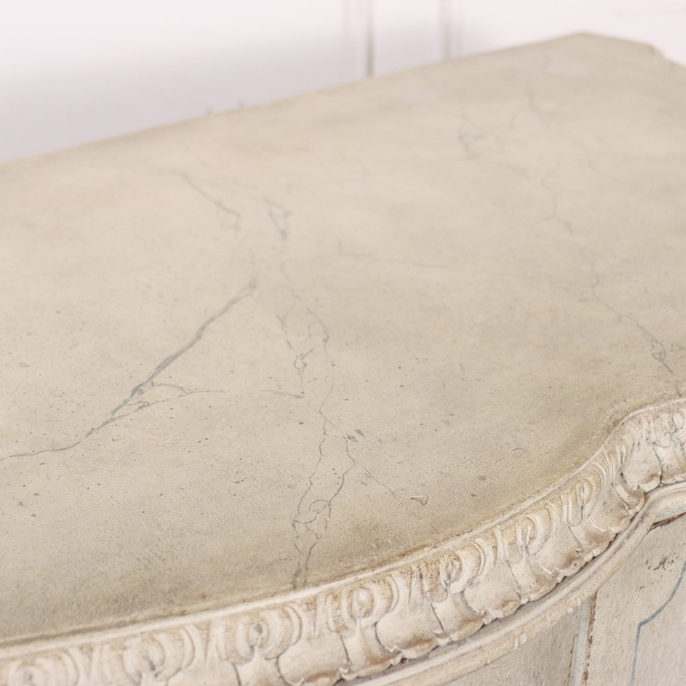 An off-white painted Italian Rococo side cabinet featuring carved acanthus leaf shoulders, a serpentine lower apron, double doors with painted blue trim, and prominent carved claw feet. View XV