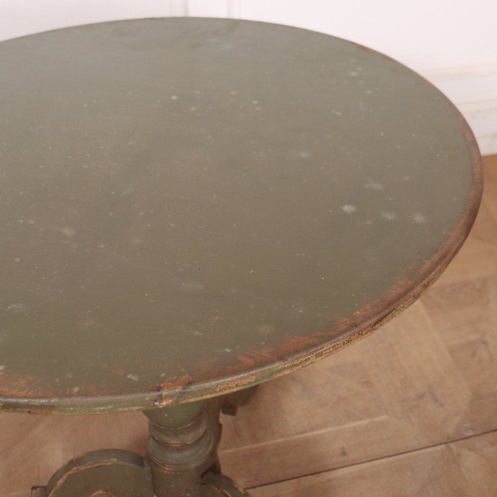 An antique Swedish painted wooden side table featuring a circular top, turned central pedestal, and scrolled tripod legs in a muted green finish. View V