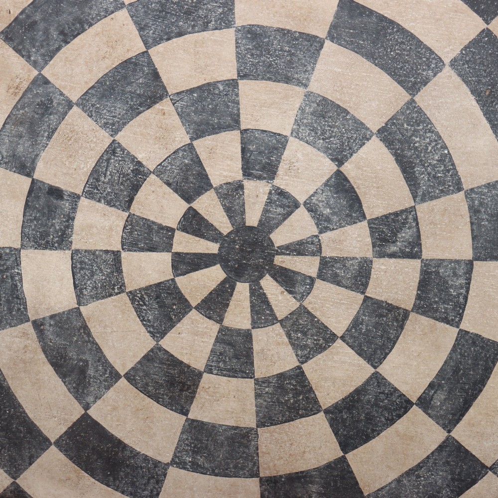 A circular tilt-top tripod table featuring a painted concentric checkerboard top in black and cream, supported by a dark three-legged base on castors. View IV
