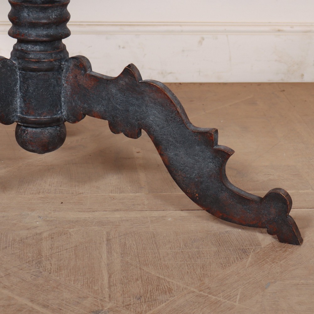 An antique Swedish round supper table featuring a dark distress-painted top set on a turned baluster pedestal with shaped tripod legs. View III
