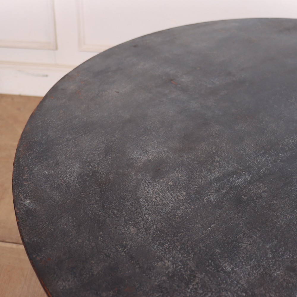 An antique Swedish round supper table featuring a dark distress-painted top set on a turned baluster pedestal with shaped tripod legs. View VII