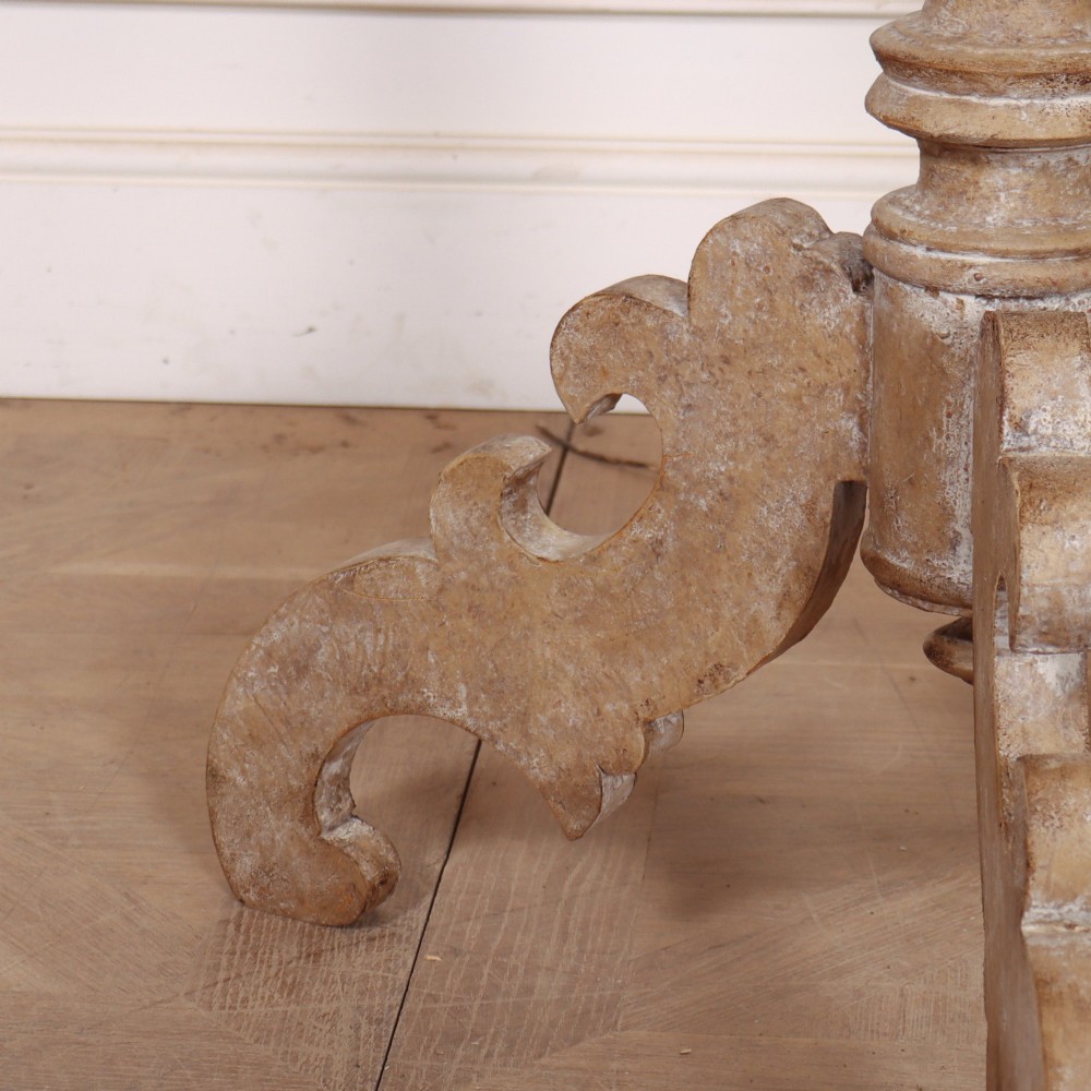 A circular painted Swedish side table featuring a turned central pedestal column resting on three carved scroll tripod legs with a distressed grey paint finish. View II