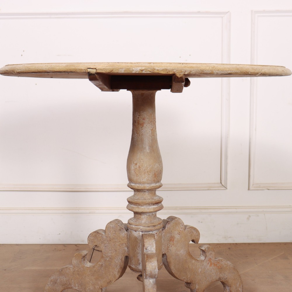 A circular painted Swedish side table featuring a turned central pedestal column resting on three carved scroll tripod legs with a distressed grey paint finish. View V