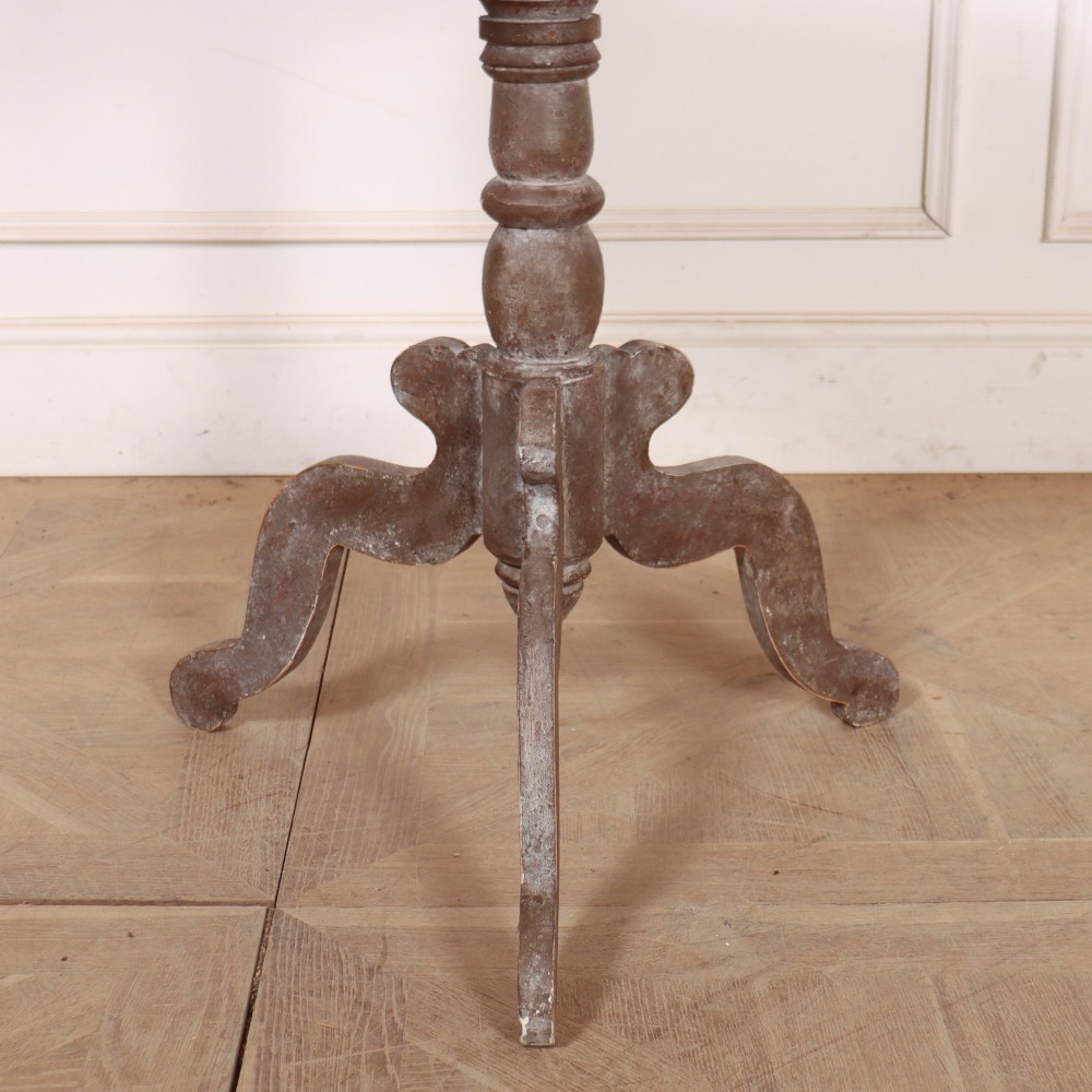 An antique Swedish painted lamp table featuring a circular top supported by a turned central column and three carved scrolled legs. View II