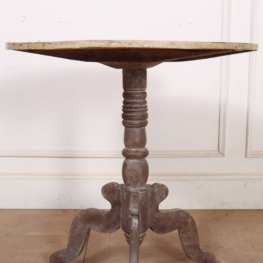 An antique Swedish painted lamp table featuring a circular top supported by a turned central column and three carved scrolled legs. View III