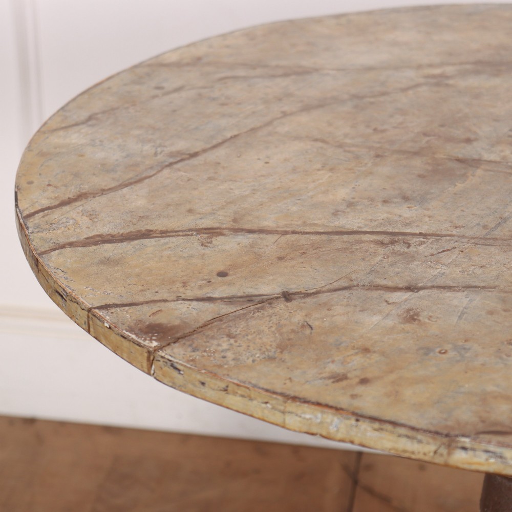An antique Swedish painted lamp table featuring a circular top supported by a turned central column and three carved scrolled legs. View V