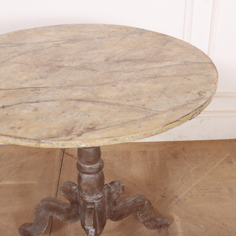 An antique Swedish painted lamp table featuring a circular top supported by a turned central column and three carved scrolled legs. View VI