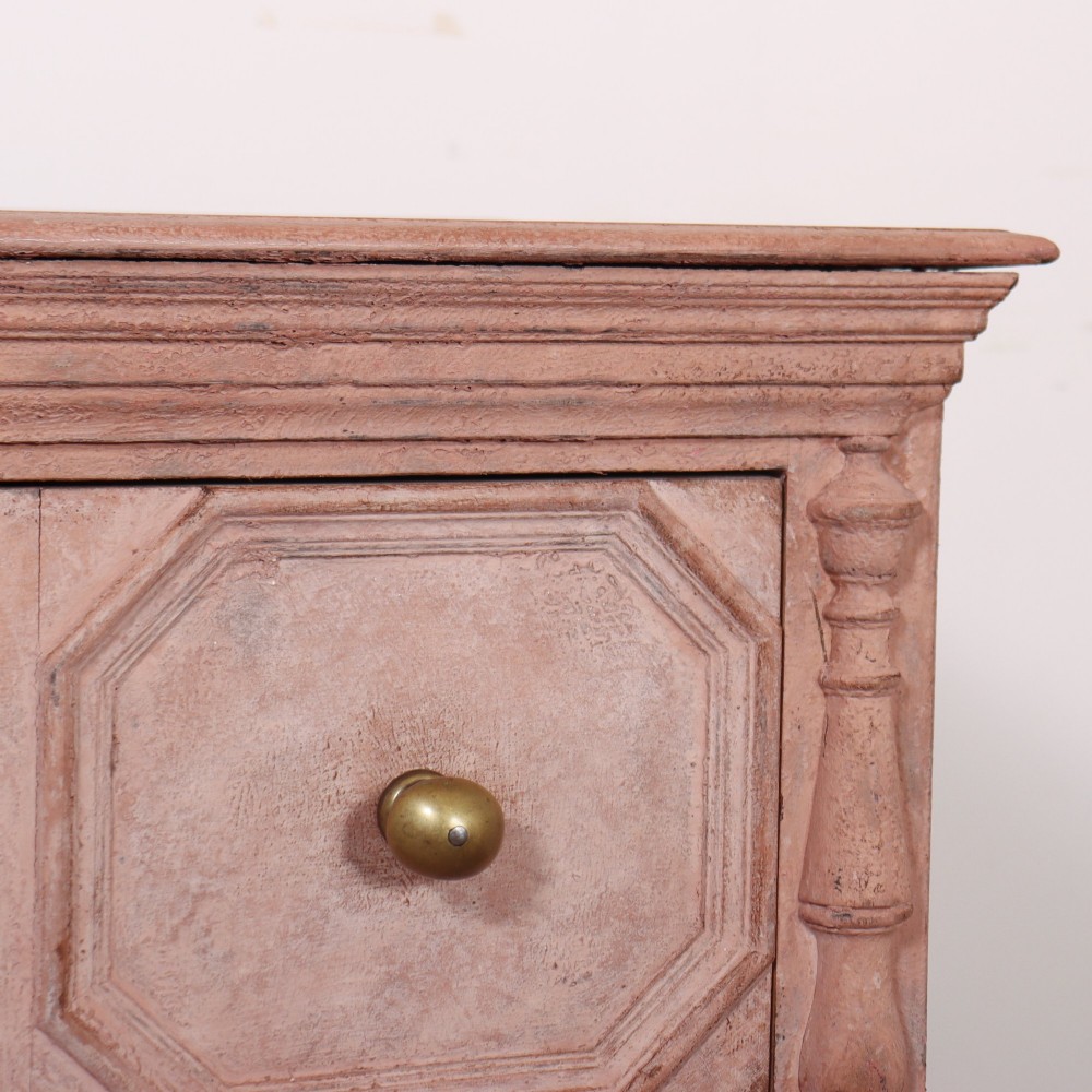 A long English painted dresser base featuring five geometric mouldings across the drawer fronts, brass knobs, turned legs, and a low connecting stretcher. View VII