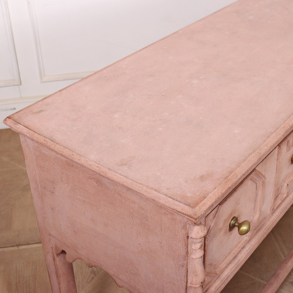 A long English painted dresser base featuring five geometric mouldings across the drawer fronts, brass knobs, turned legs, and a low connecting stretcher. View IX