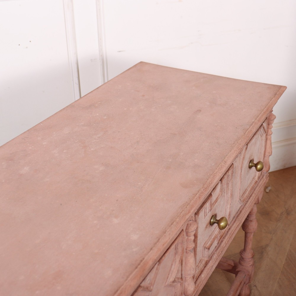 A long English painted dresser base featuring five geometric mouldings across the drawer fronts, brass knobs, turned legs, and a low connecting stretcher. View X