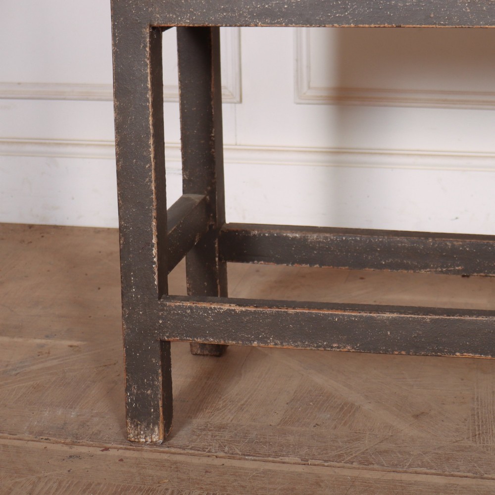 An antique English painted server table featuring a grey painted top over two dark grey drawers with metal drop handles and a low stretcher base. View V