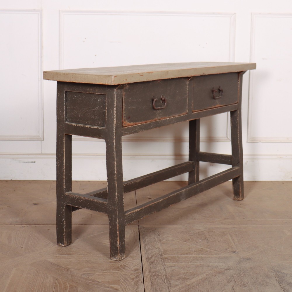An antique English painted server table featuring a grey painted top over two dark grey drawers with metal drop handles and a low stretcher base. View VII