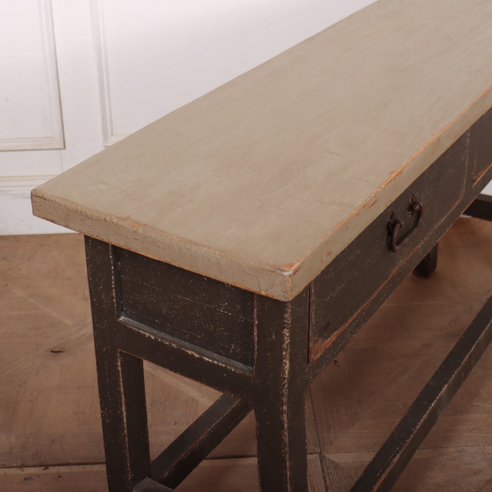 An antique English painted server table featuring a grey painted top over two dark grey drawers with metal drop handles and a low stretcher base. View VIII