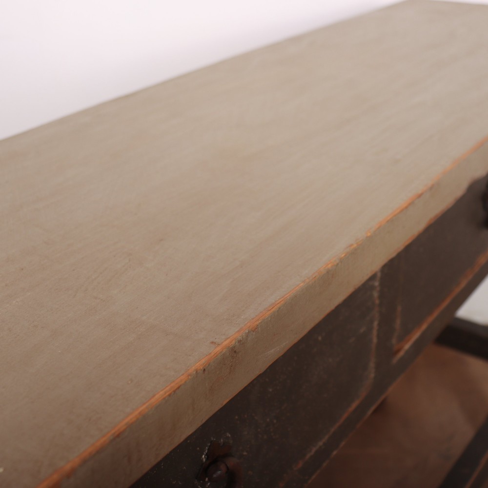 An antique English painted server table featuring a grey painted top over two dark grey drawers with metal drop handles and a low stretcher base. View X