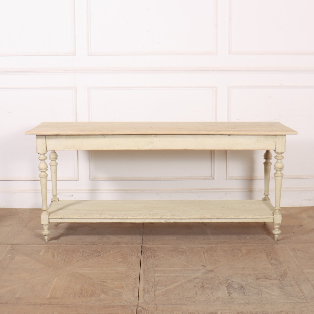 A long French painted drapers table featuring a natural pine top, a cream-painted base with turned legs, and a low open undershelf. View VI