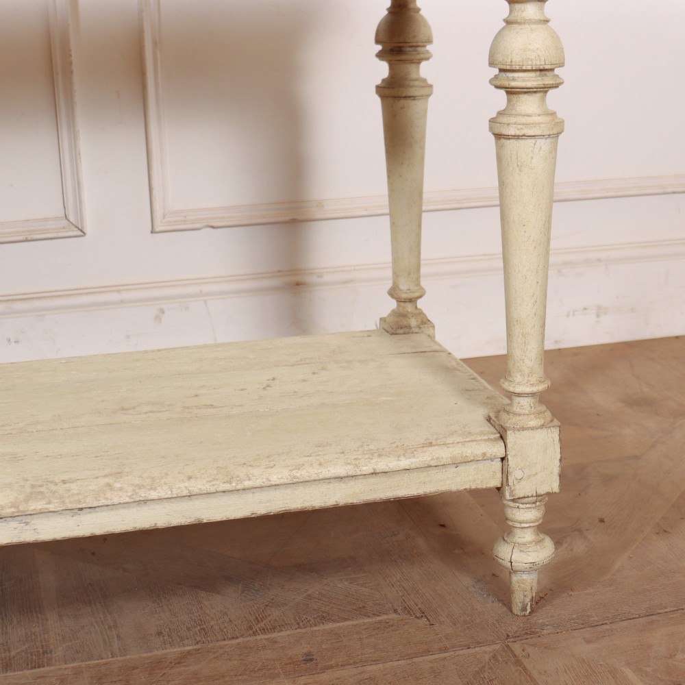 A long French painted drapers table featuring a natural pine top, a cream-painted base with turned legs, and a low open undershelf. View VII