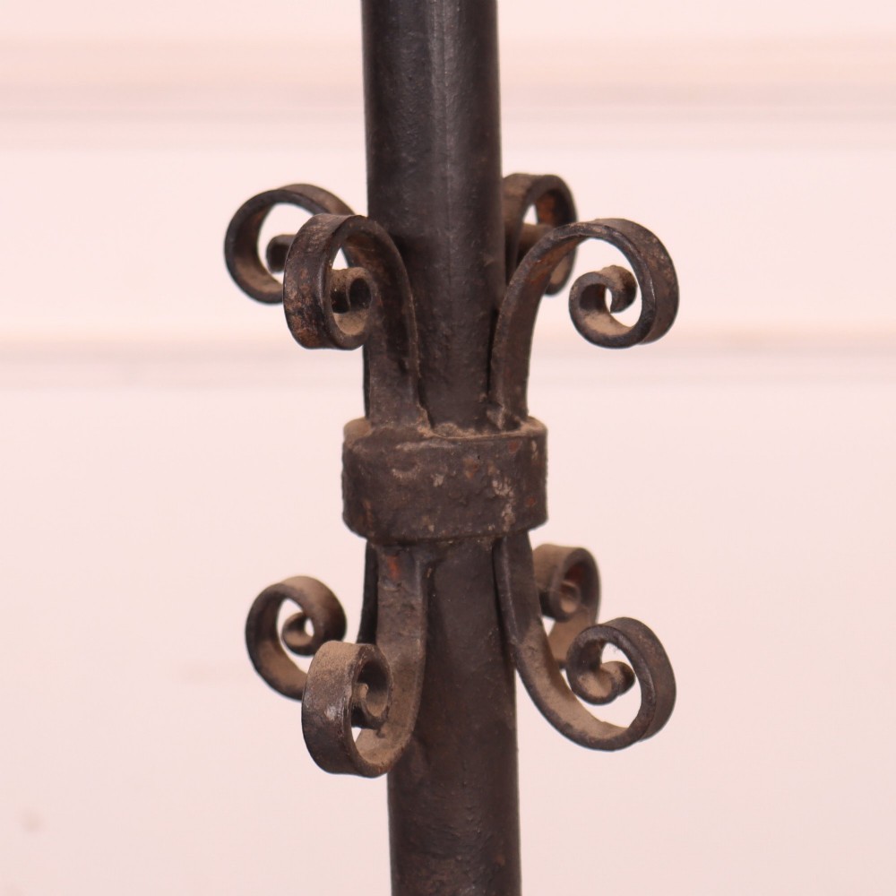 A tall dark wrought iron floor candelabra featuring scrollwork arms holding six candle sconces above a decorated stem and tripod scroll base. View VII