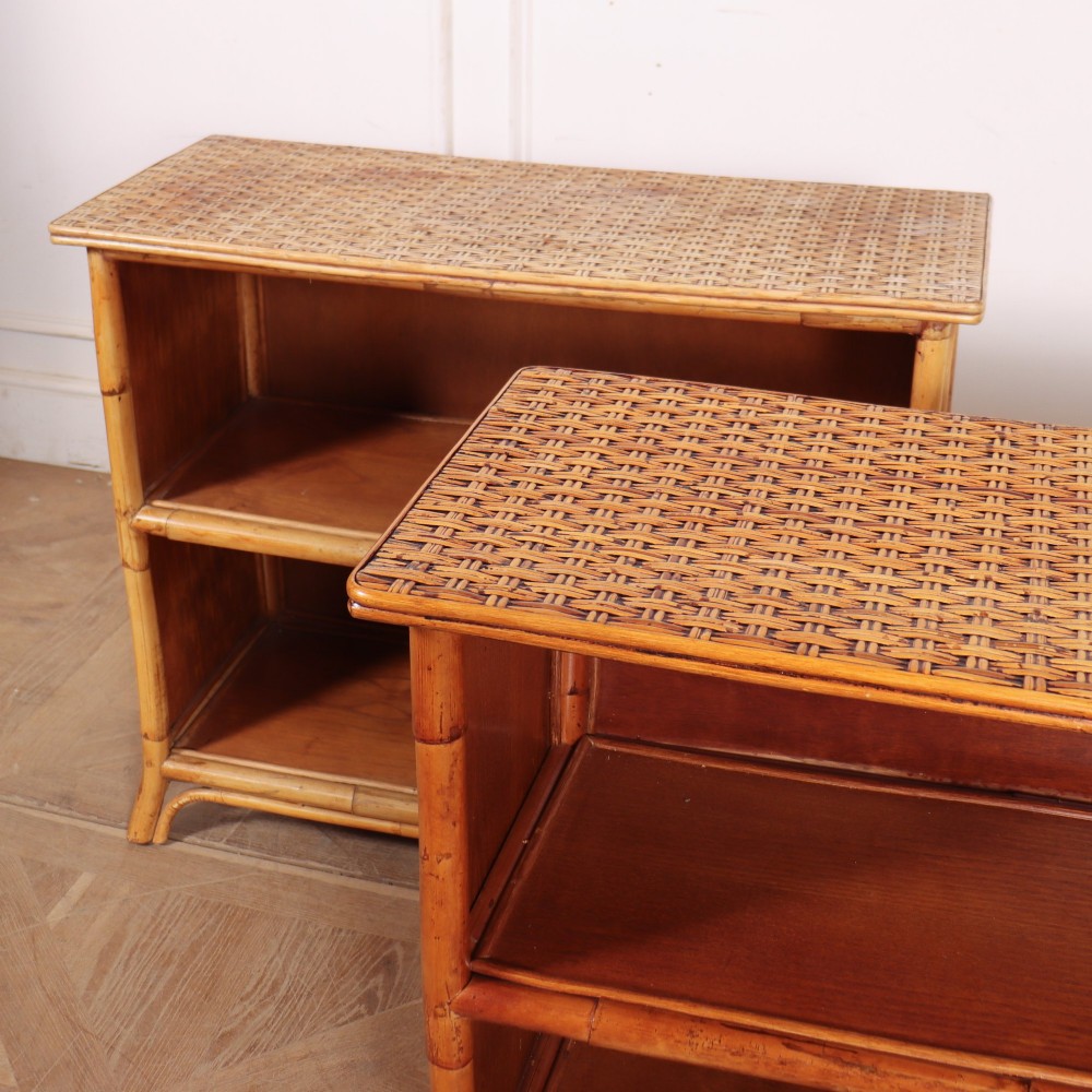 A pair of low vintage bamboo bookcases featuring woven cane tops and two open wooden shelves. View VI