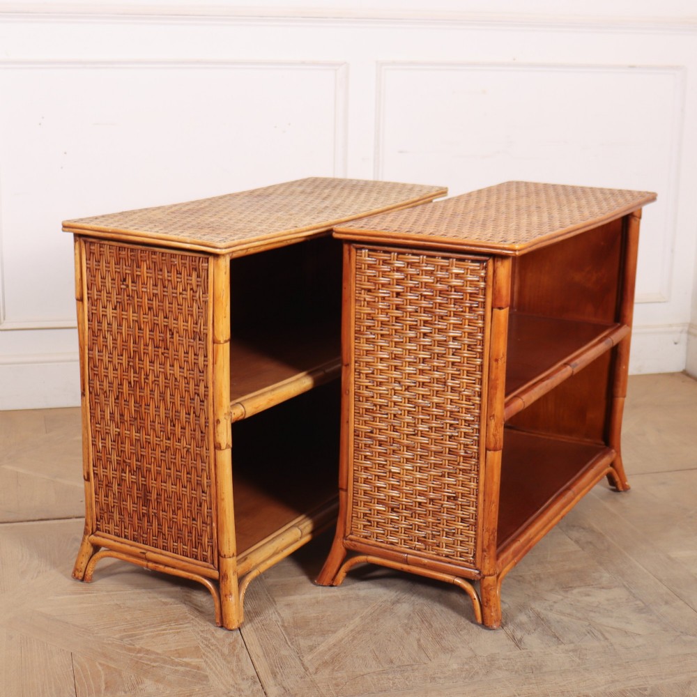 A pair of low vintage bamboo bookcases featuring woven cane tops and two open wooden shelves. View XIII