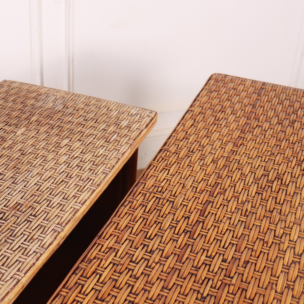 A pair of low vintage bamboo bookcases featuring woven cane tops and two open wooden shelves. View XV