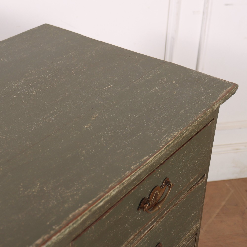 A distressed sage green painted wooden chest of drawers featuring two short over three long drawers with decorative brass handles and bracket feet. View IX
