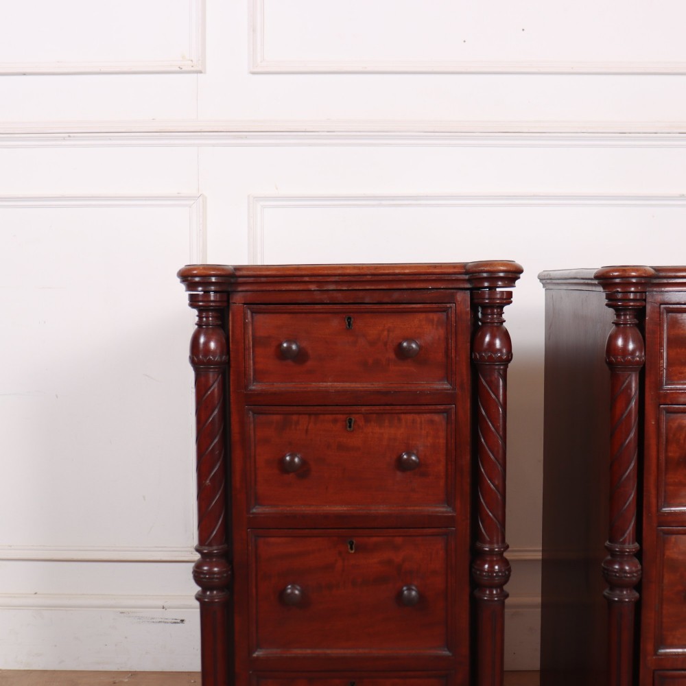 A matching pair of tall mahogany bedside chests featuring four drawers each, turned twist column pilasters, and round wooden handles. View II