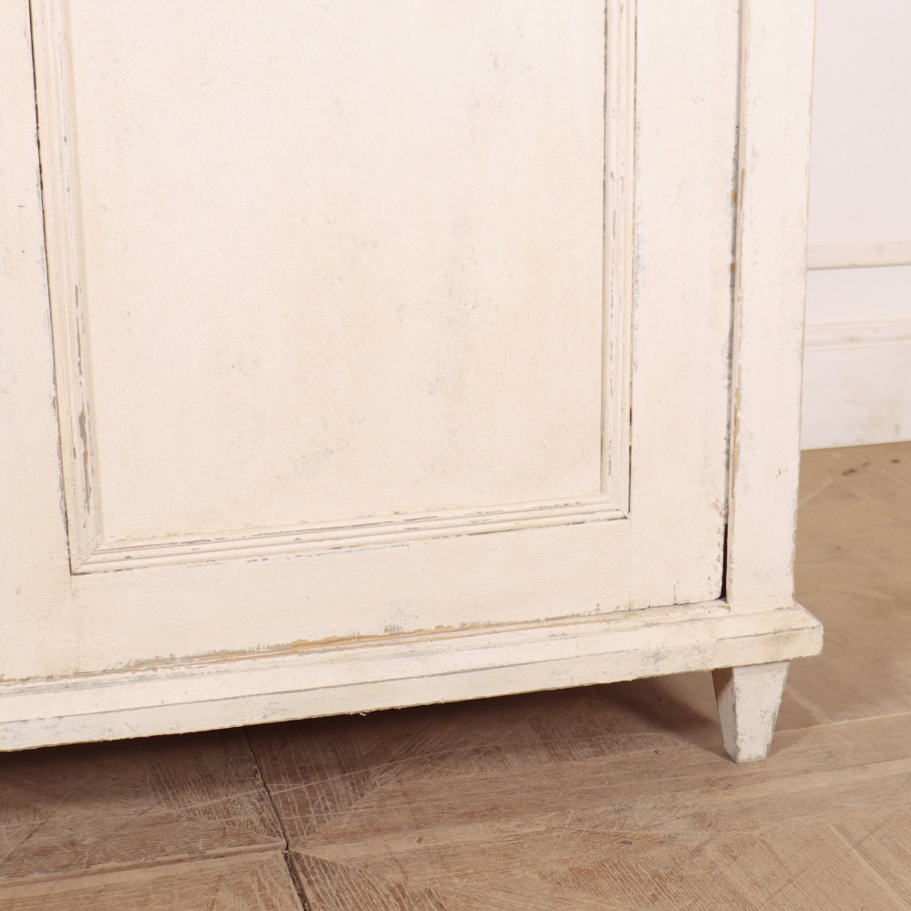 An off-white painted Continental wooden buffet featuring three reeded top drawers with round brass knobs above two large panelled cupboard doors and a grey painted top surface. View V