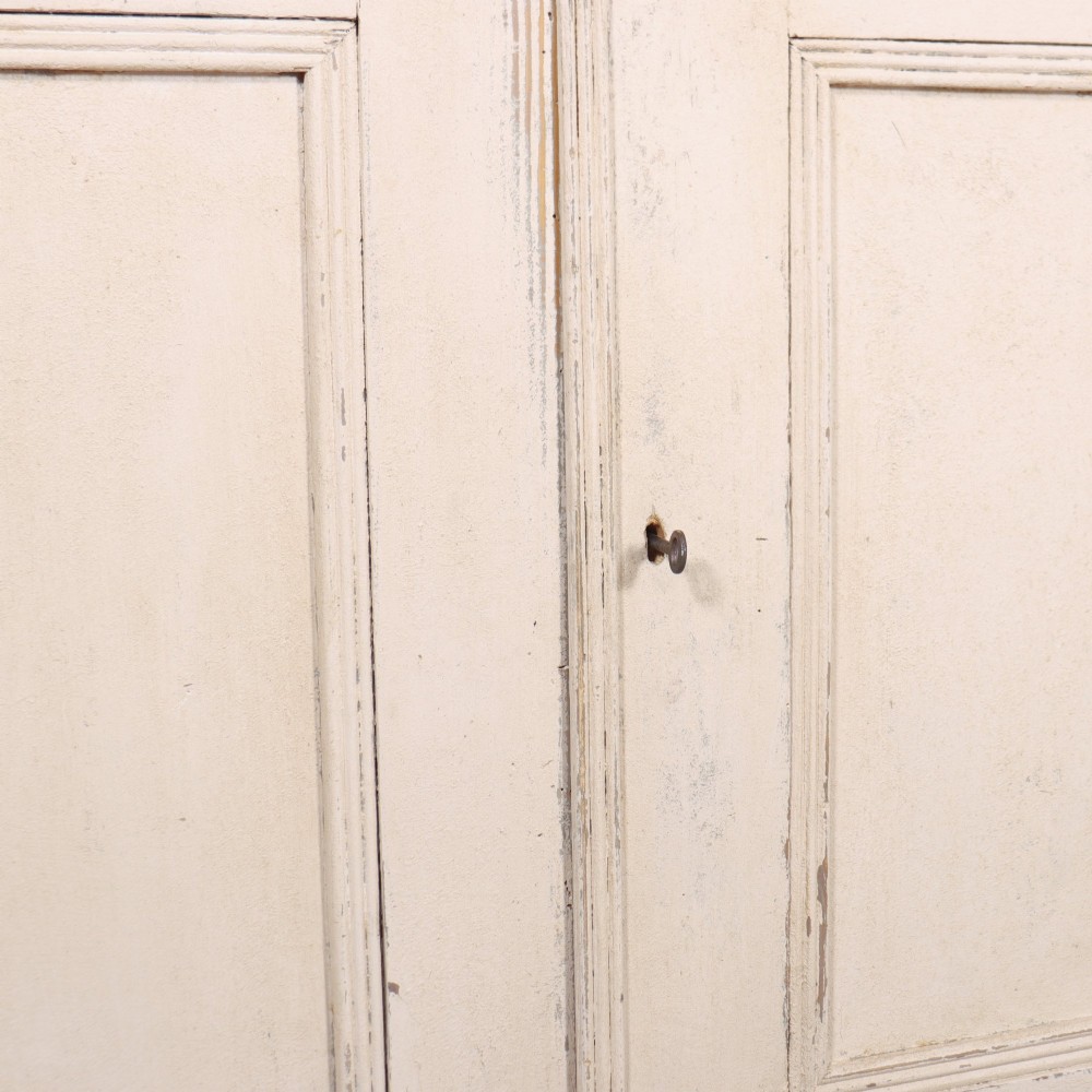 An off-white painted Continental wooden buffet featuring three reeded top drawers with round brass knobs above two large panelled cupboard doors and a grey painted top surface. View VII