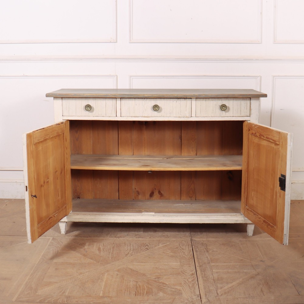 An off-white painted Continental wooden buffet featuring three reeded top drawers with round brass knobs above two large panelled cupboard doors and a grey painted top surface. View VIII