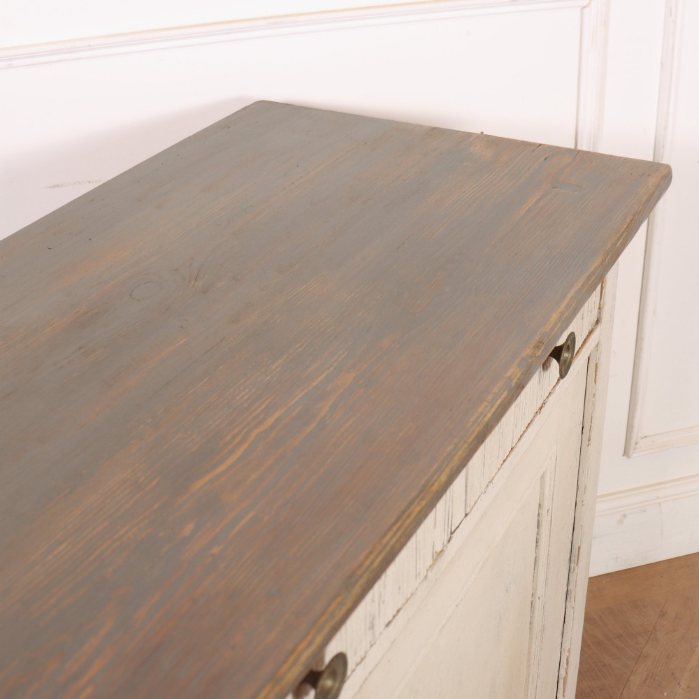 An off-white painted Continental wooden buffet featuring three reeded top drawers with round brass knobs above two large panelled cupboard doors and a grey painted top surface. View XI