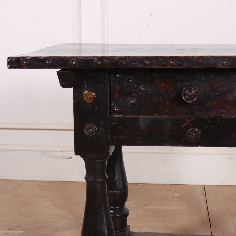 A dark brown Italian walnut side table featuring turned legs, a single frieze drawer, brass stud embellishments, and a low box stretcher. View II