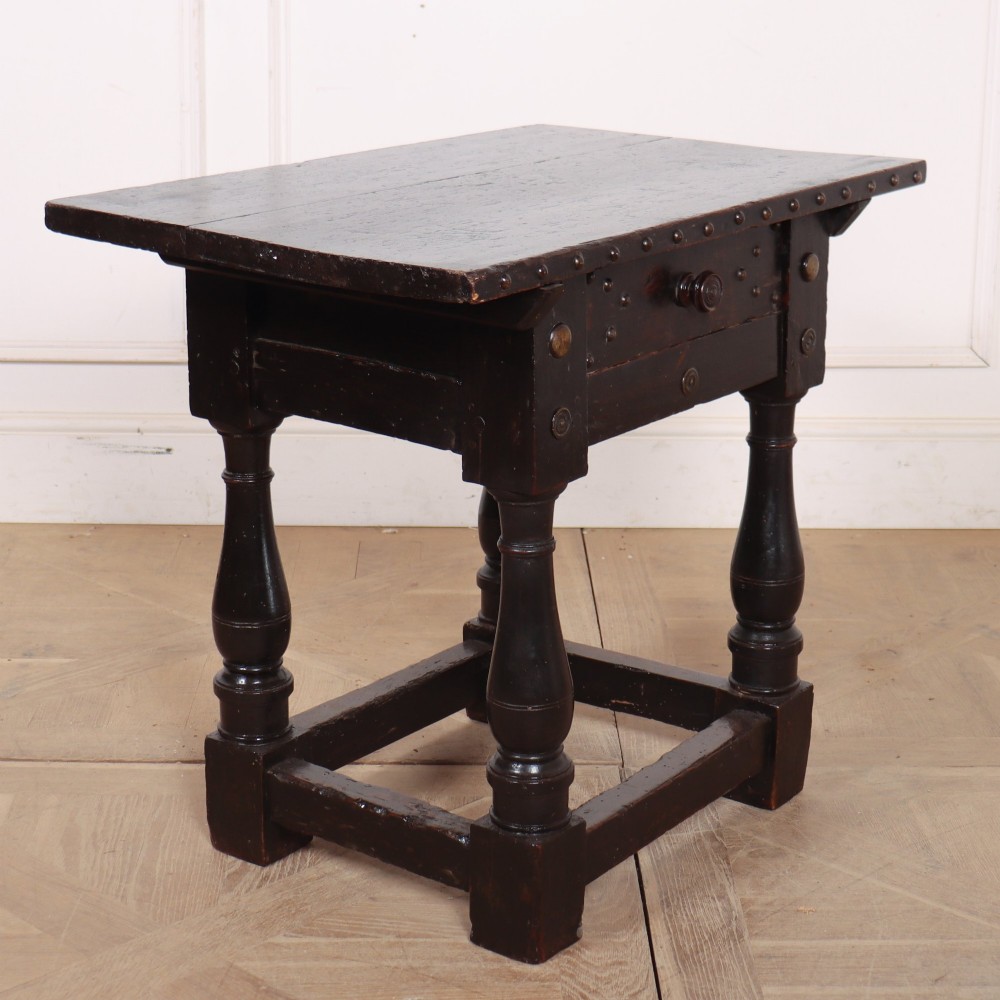 A dark brown Italian walnut side table featuring turned legs, a single frieze drawer, brass stud embellishments, and a low box stretcher. View VII