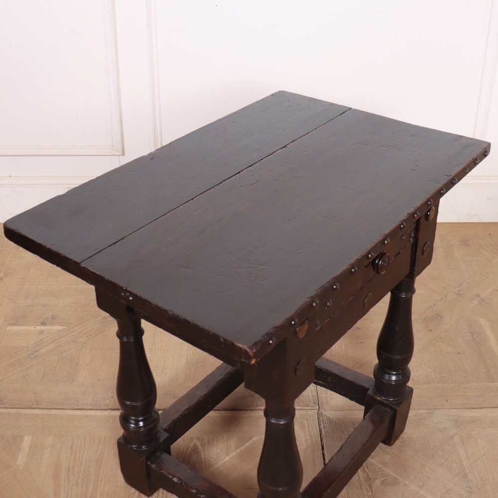 A dark brown Italian walnut side table featuring turned legs, a single frieze drawer, brass stud embellishments, and a low box stretcher. View VIII