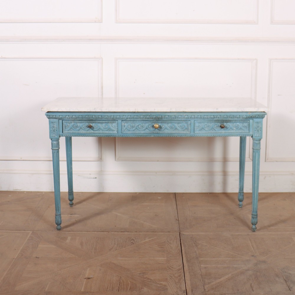 An Italian Neoclassical style light blue painted console table featuring a white marble top, three carved frieze drawers, and fluted legs.