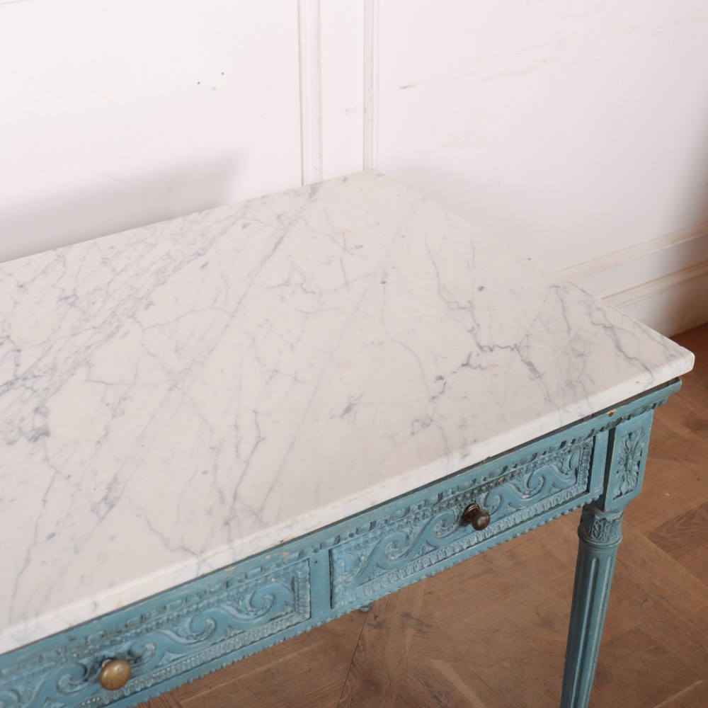 An Italian Neoclassical style light blue painted console table featuring a white marble top, three carved frieze drawers, and fluted legs. View VIII