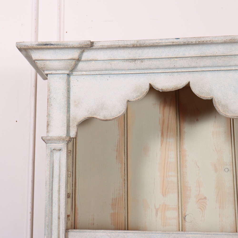 A tall, narrow French painted wooden open bookcase featuring a scalloped frieze, moulded cornice, and planked back. View II