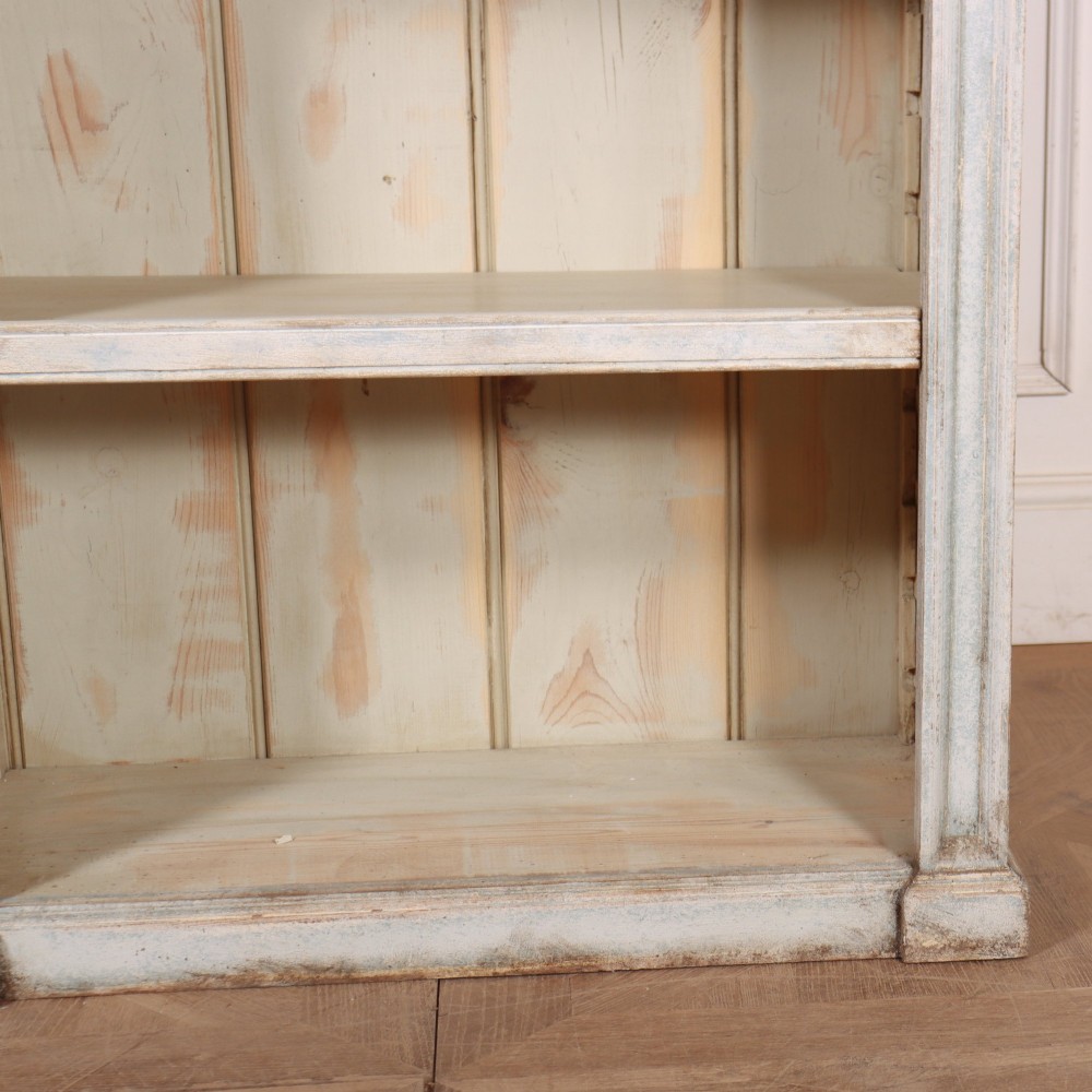 A tall, narrow French painted wooden open bookcase featuring a scalloped frieze, moulded cornice, and planked back. View V