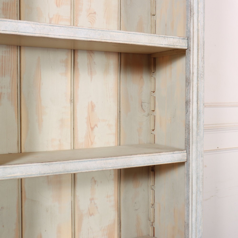 A tall, narrow French painted wooden open bookcase featuring a scalloped frieze, moulded cornice, and planked back. View VI