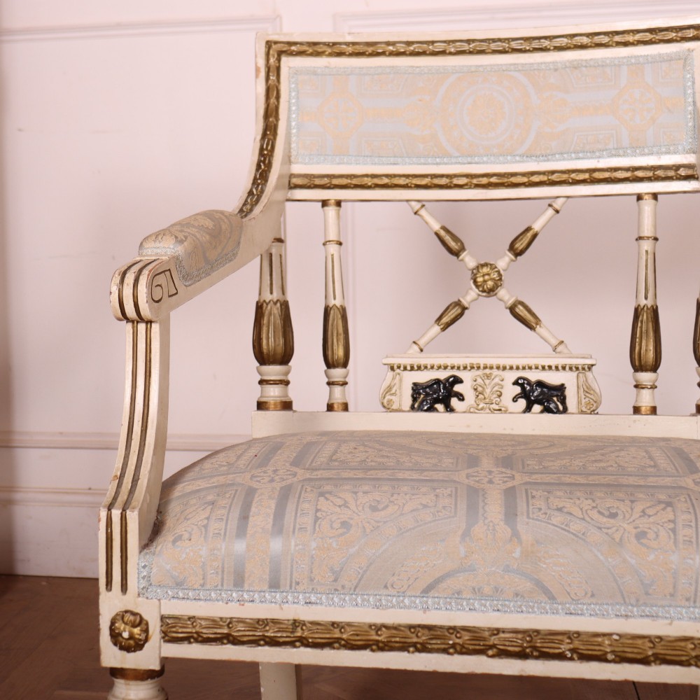 A pair of Swedish Empire style armchairs with pale cream and gilt painted frames, X-back spindle details, and light blue patterned fabric upholstery. View V