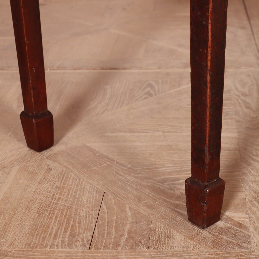 An eighteenth-century English oak dresser base featuring three drawers with brass swan-neck handles, raised on four slender straight legs. View VIII