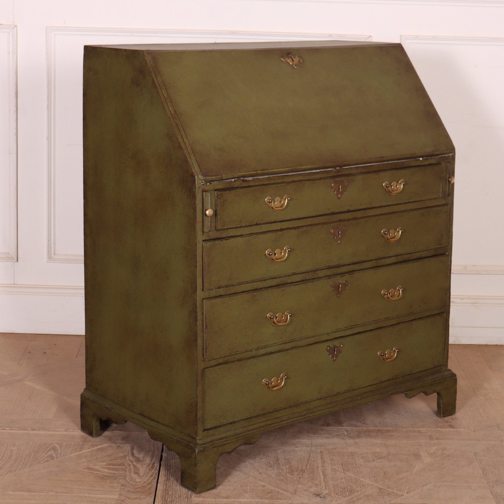 An antique English slant-front bureau with an olive green painted finish, brass handles, keyhole escutcheons, and four drawers resting on bracket feet. View XII