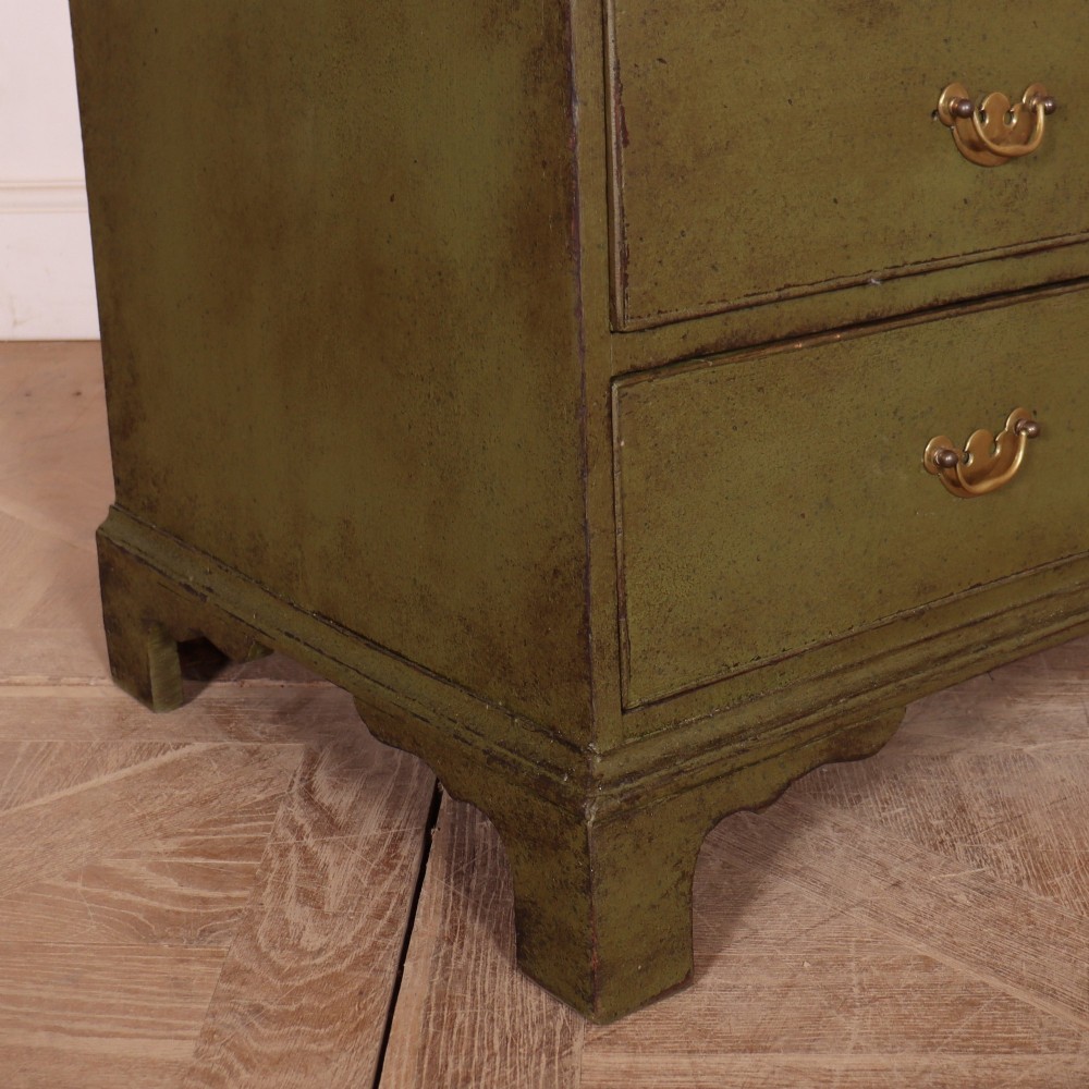 An antique English slant-front bureau with an olive green painted finish, brass handles, keyhole escutcheons, and four drawers resting on bracket feet. View XIII