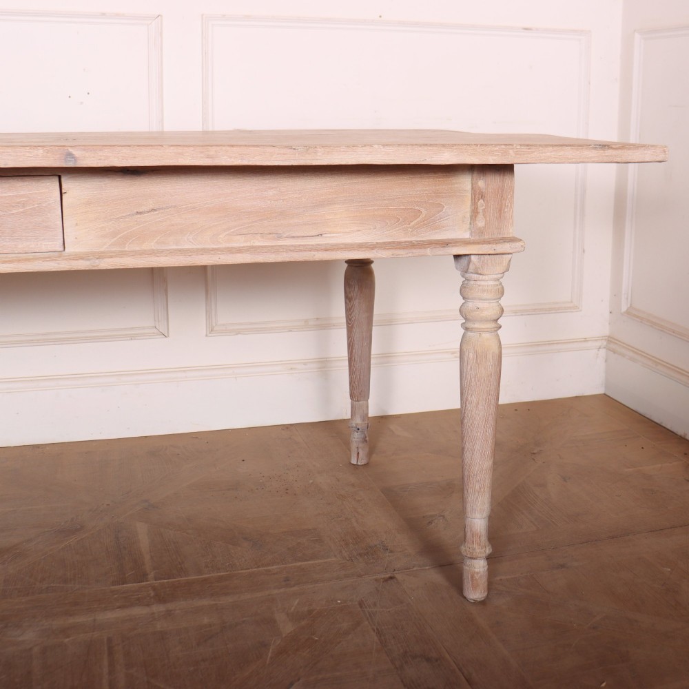 A 19th-century Spanish rustic elm dining table featuring a pale natural finish, four turned legs, and a single frieze drawer with a metal ring pull. View II