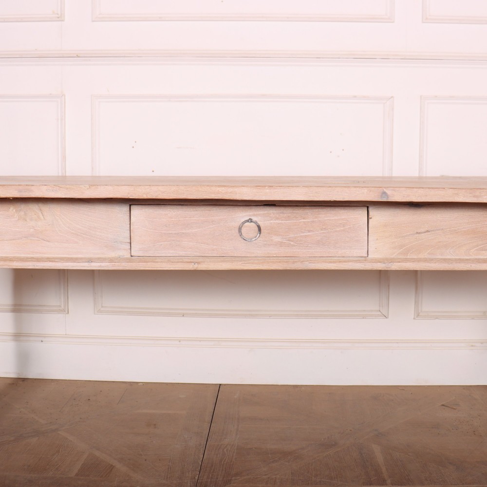 A 19th-century Spanish rustic elm dining table featuring a pale natural finish, four turned legs, and a single frieze drawer with a metal ring pull. View IV